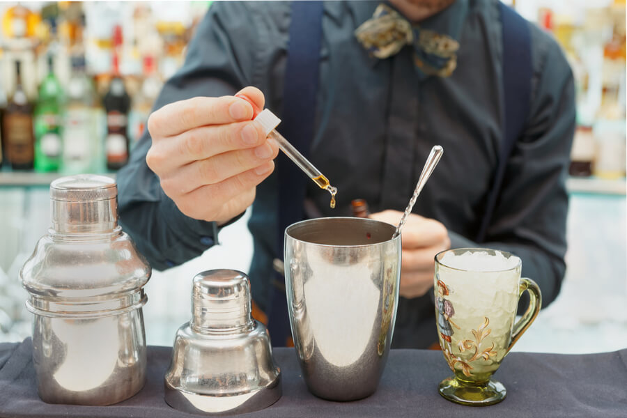 A bartender mixing drinks with CBD oil.